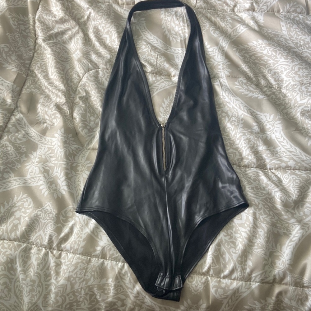 Black bodysuit zipper bust with snap bottom.